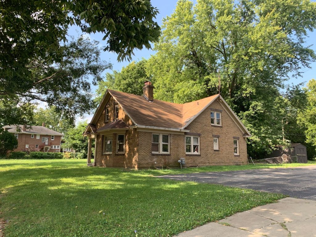 Mastering the First Impression: Your intriguing post title goes here Charming brick house surrounded by trees in a quiet Decatur neighborhood. Perfect for real estate and lifestyle imagery.